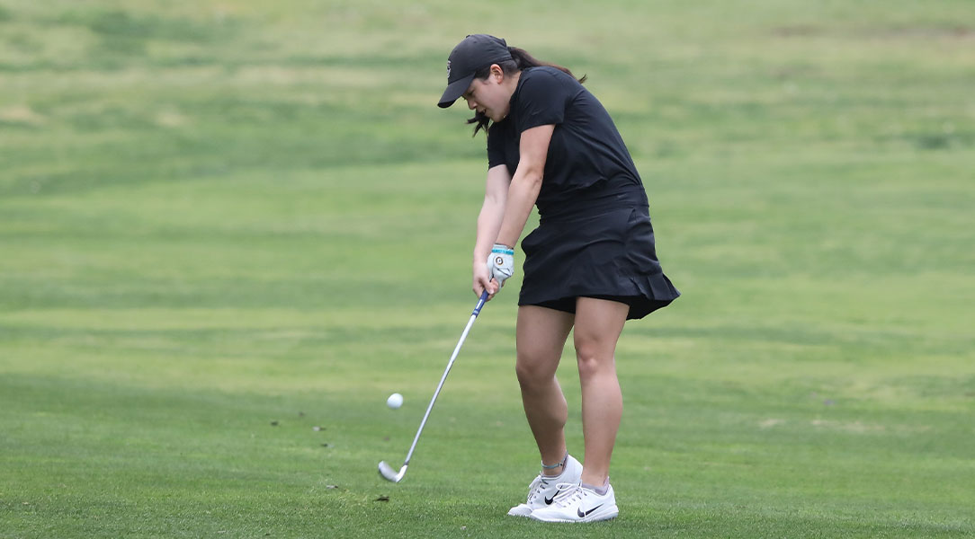 Kristen Lee hits the golf ball from the fairway.