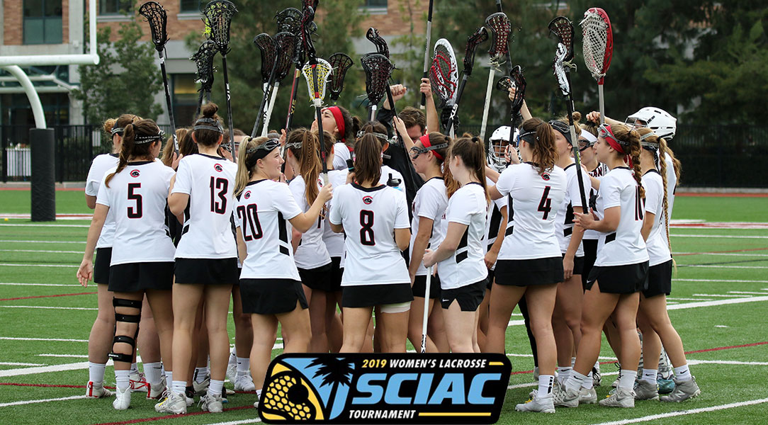 The Chapman women's lacrosse team does a team cheer before heading out onto the field.
