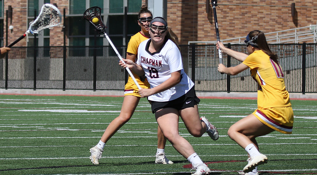 Alexandra Callaway evades lacrosse defenders.