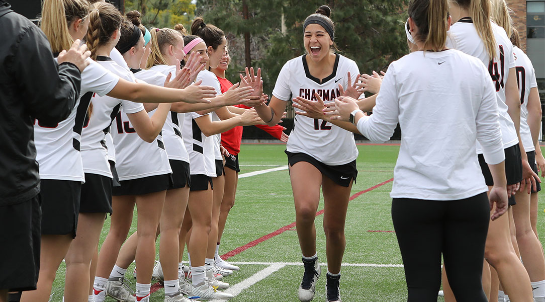 Michaela Lopez high-fives teammates.