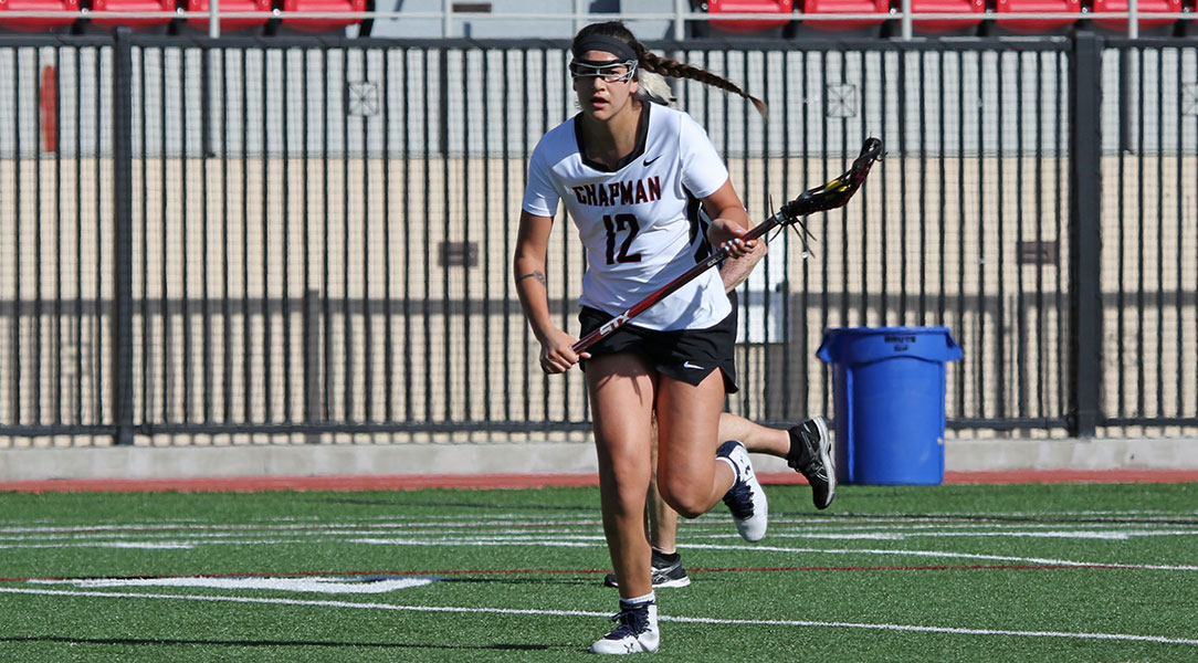 Michaela Lopez runs with her lacrosse stick.