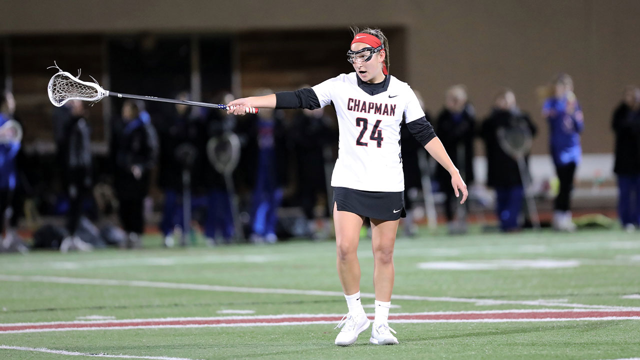 Mei-Lani Ferreira holds out her stick and talks to teammates on defense.