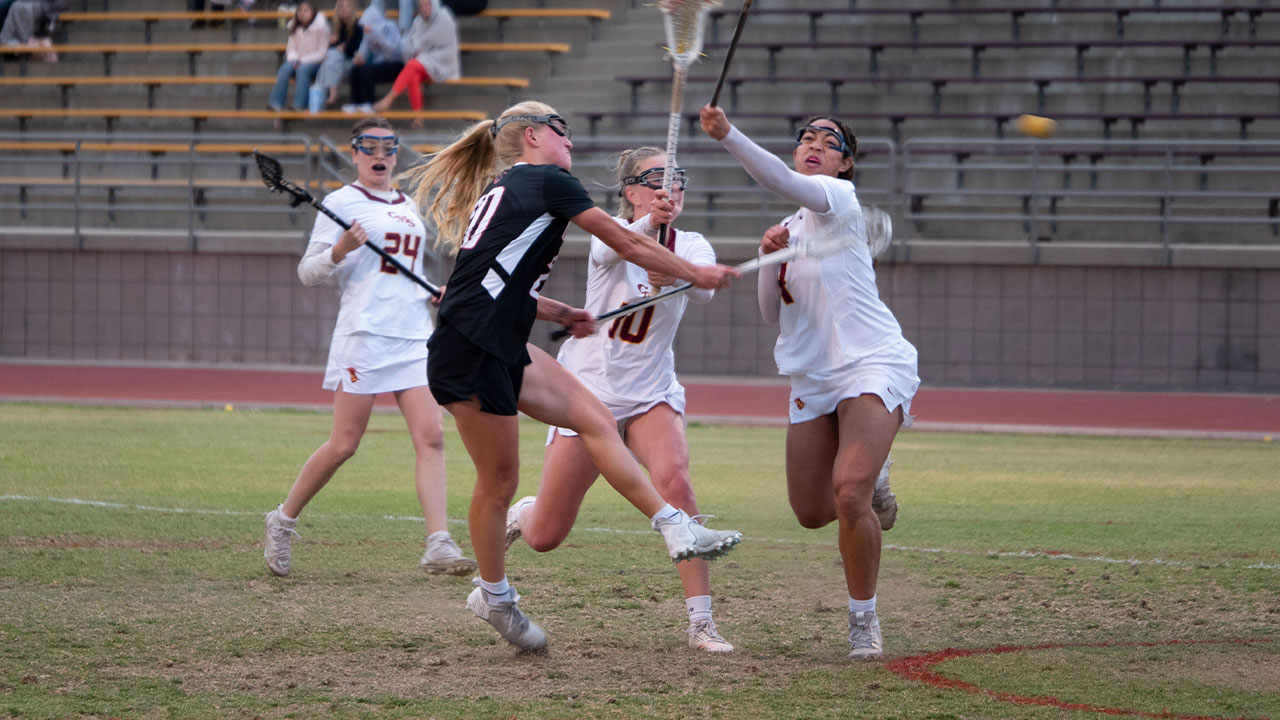 Annika Carlson shoots around a defender to a score a goal.