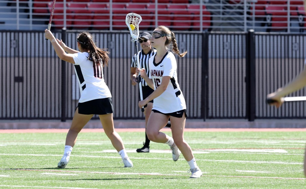 Sophia Licitra runs with the ball in her lacrosse stick.