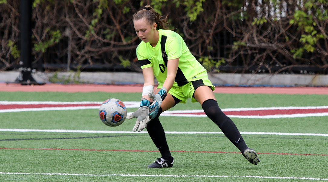 Kelsey Bland saves the ball.