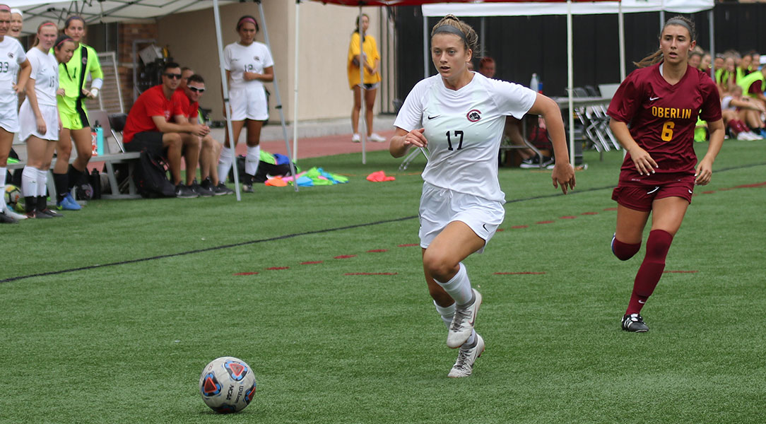 Cate Combi dribbles away from a defender.