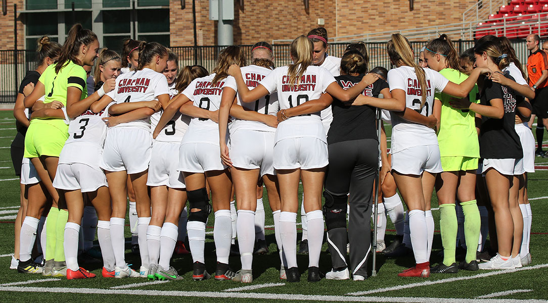 The Chapman women's soccer team huddles before the match.