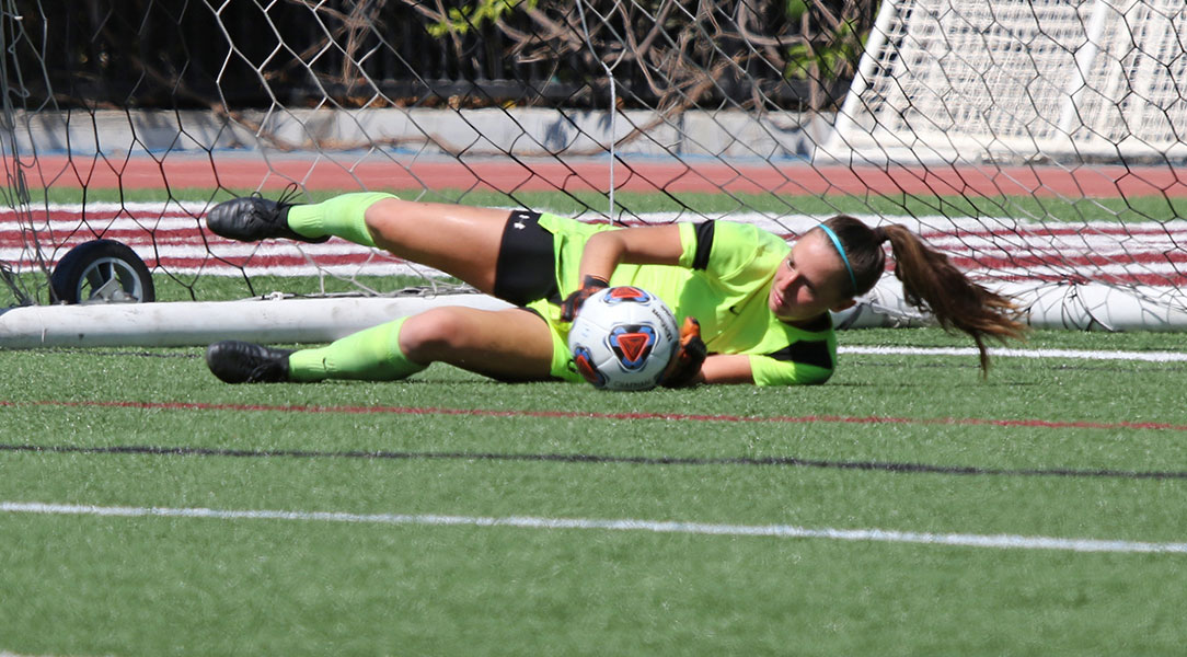 Kelsey Bland makes a diving save.
