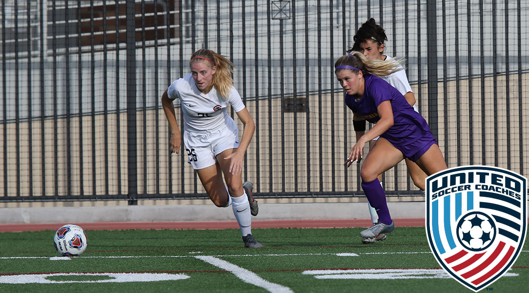 Faith Holloway dribbles away from a forward.