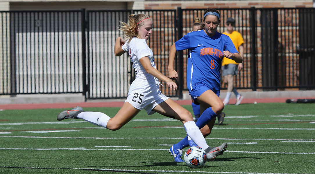 Faith Holloway kicks a soccer ball.