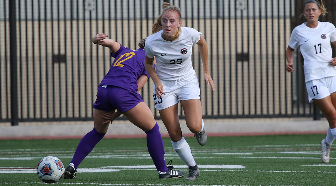 Faith Holloway dribbles past a forward.