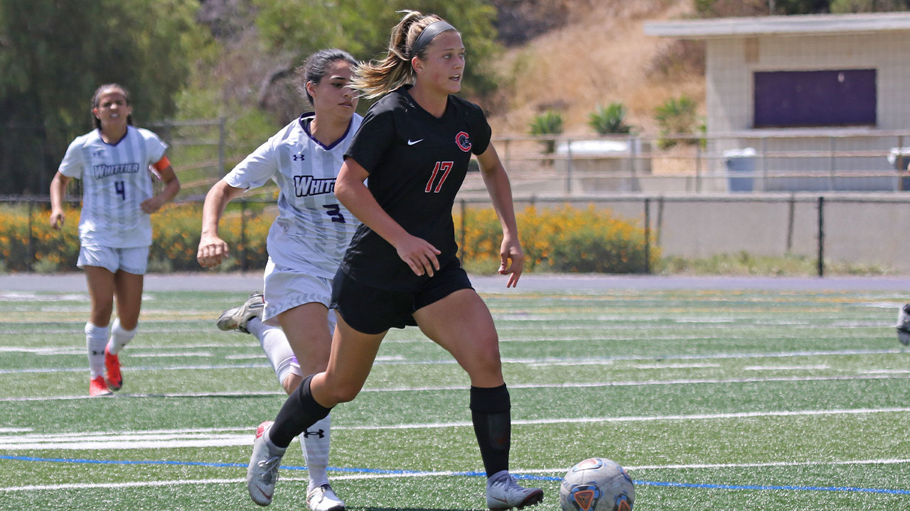 Cate Combi dribbles the soccer ball.