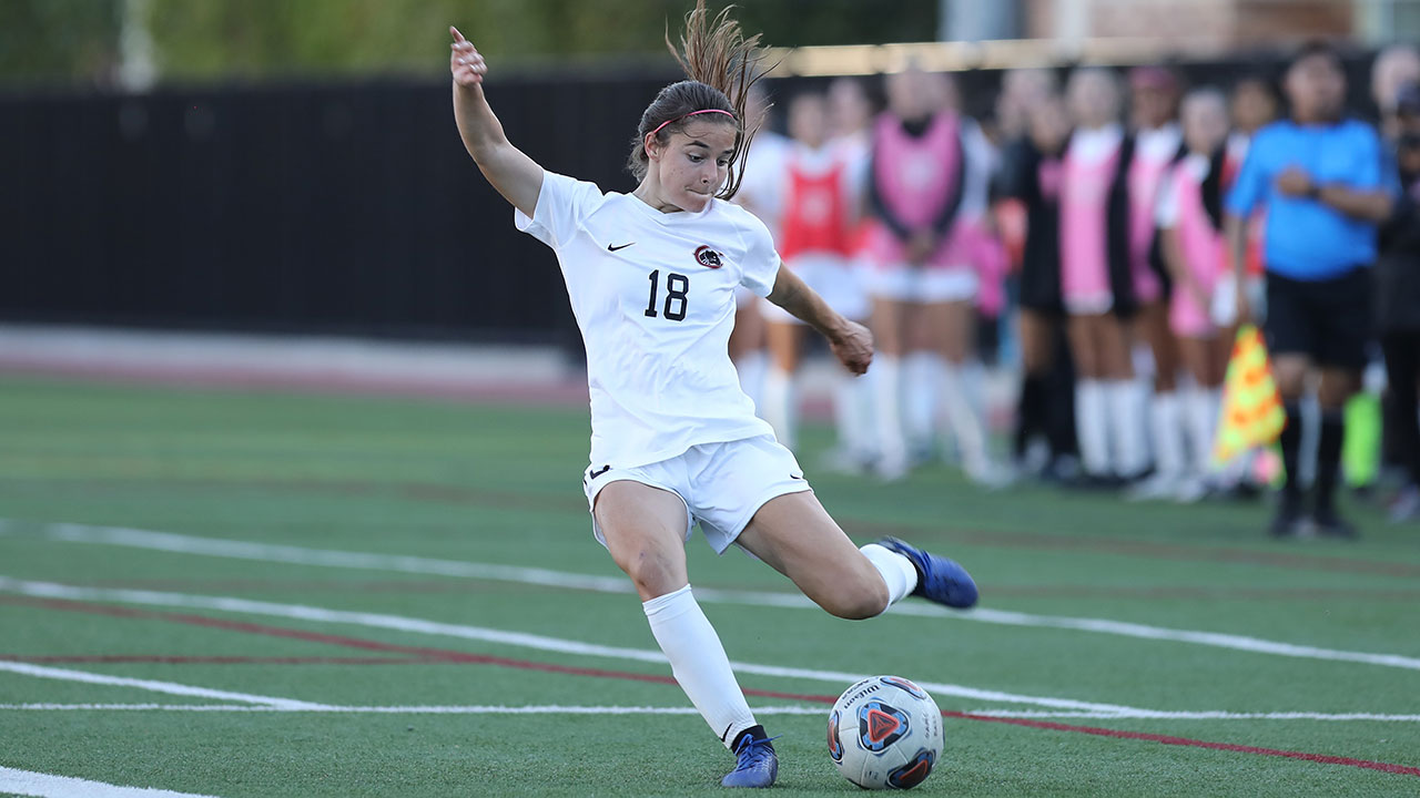 Christina Inboden is about kicks a soccer ball with her left foot.