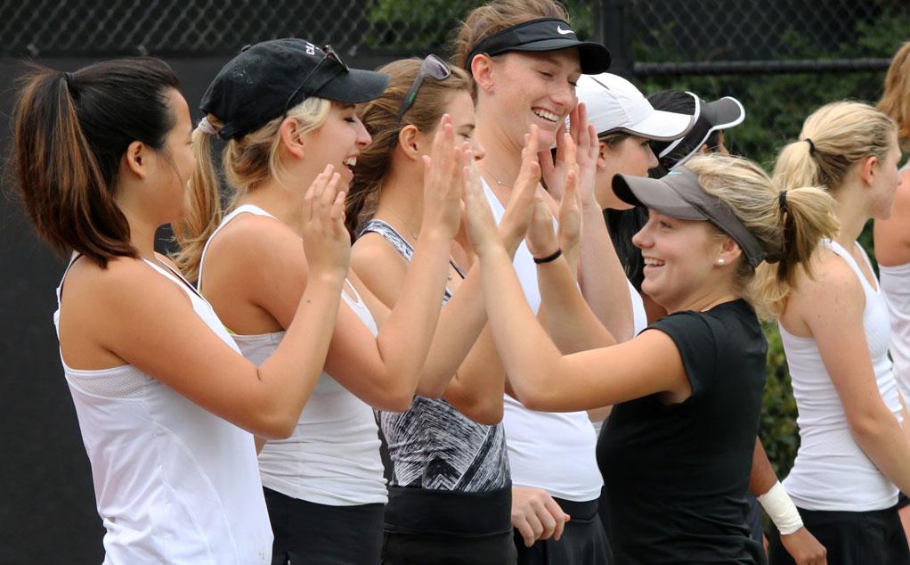 Madeline Saunders high fives teammates (photo by Larry Newman)