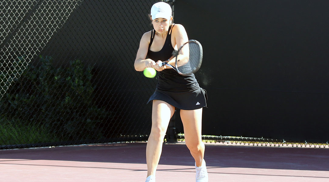 Alisa Organovich hits a back hand.