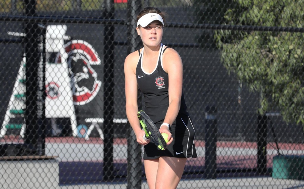 Tatum Phillips prepares to serve in tennis.