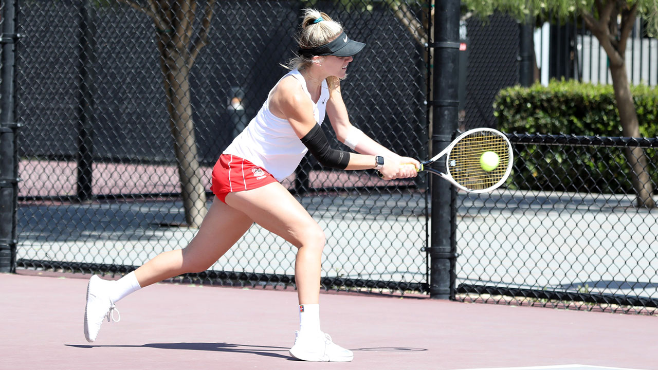 Aliya Allyn hitting a back handed shot in tennis.