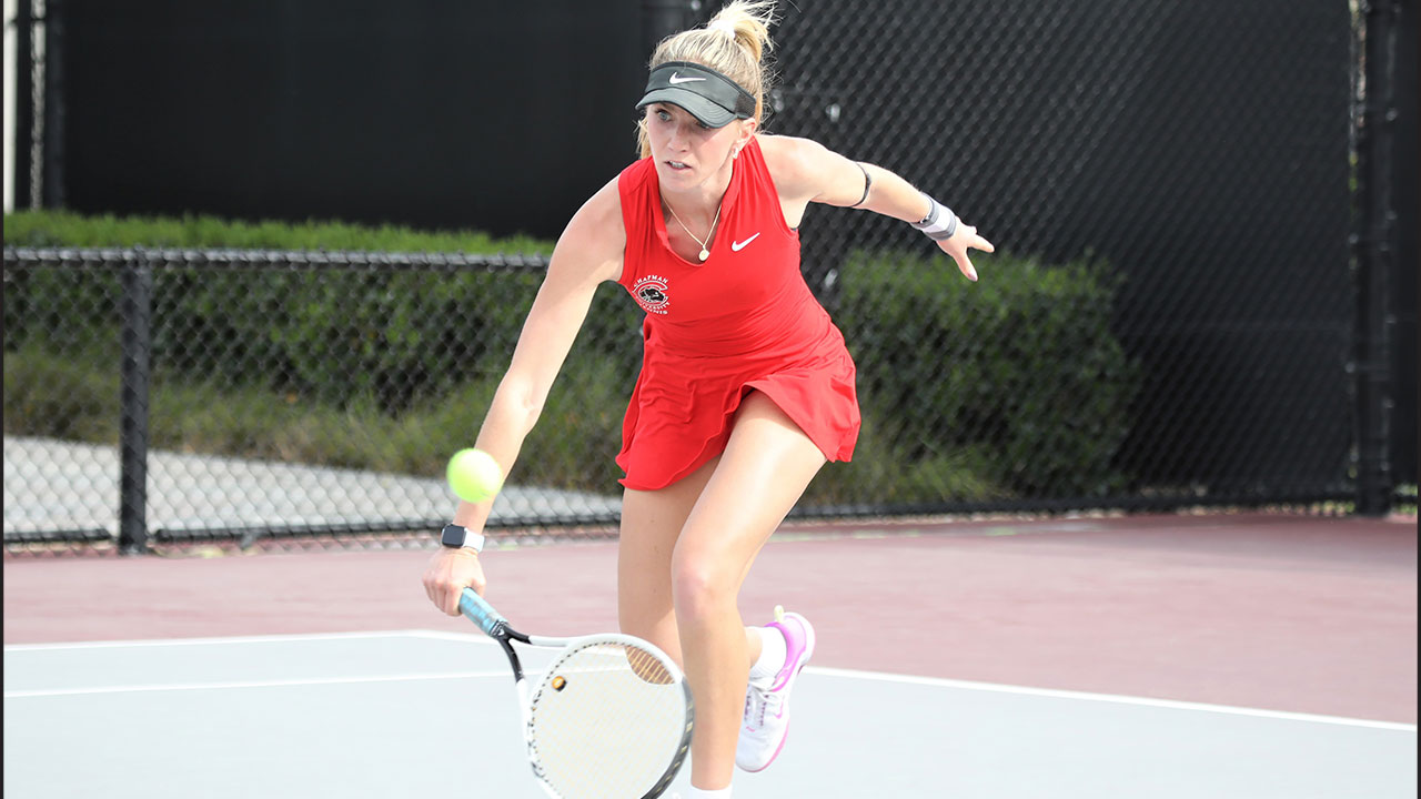 Aliya Allyn reaches with her racquet to hit a tennis ball.