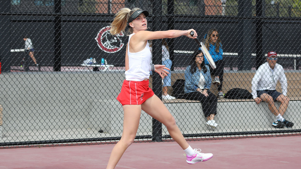 Aliya Allyn follows through after hitting a tennis ball.