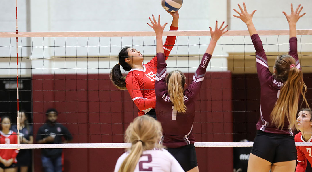 Mavis Lui tips a ball over blockers.