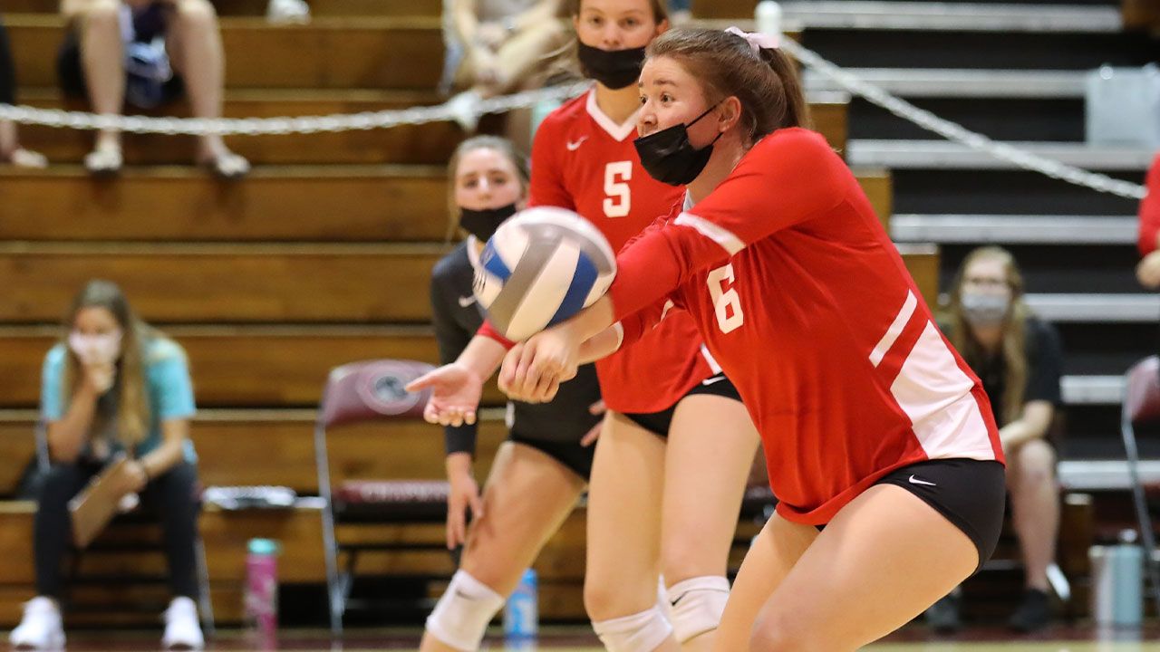 Jessi Lumsden passes a volleyball with her forearms.
