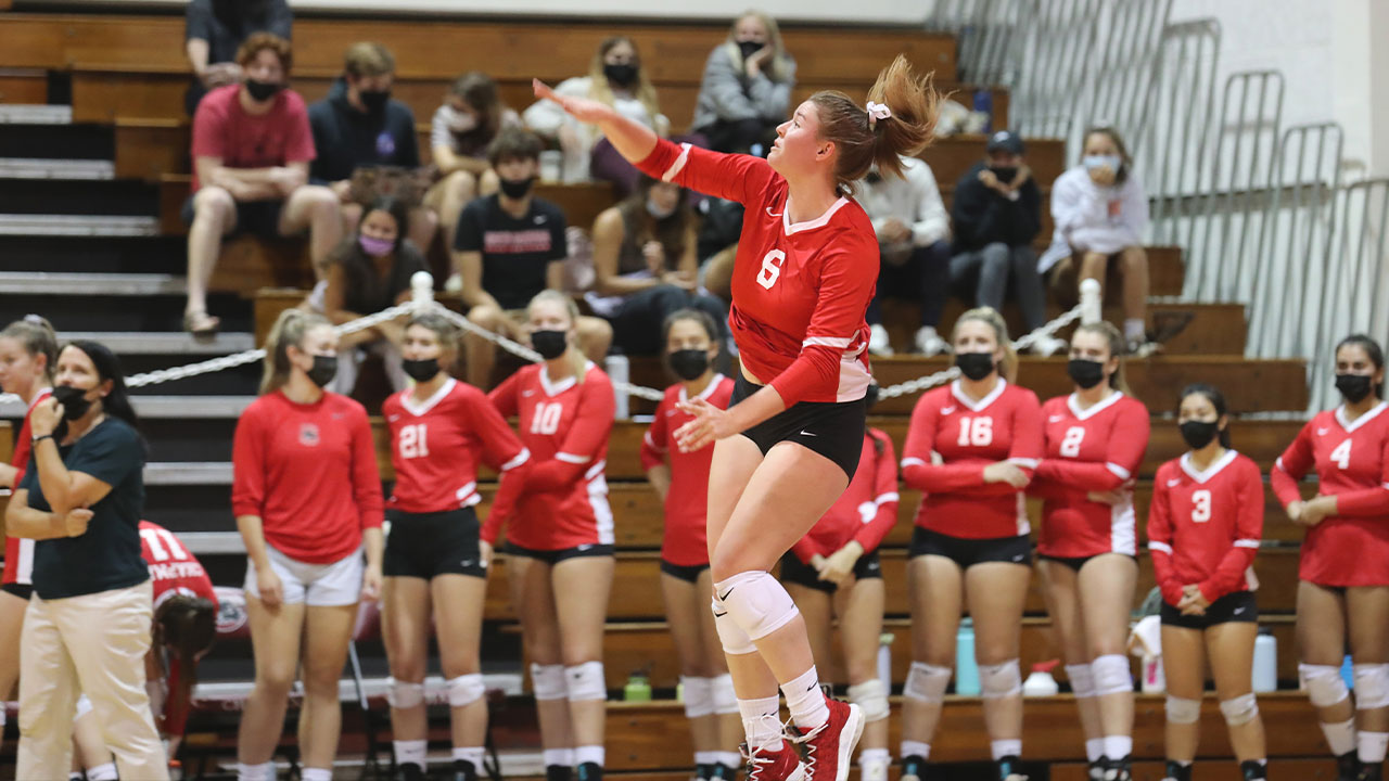 Jessi Lumsden serves a volleyball.