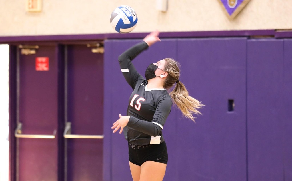 Cat Helgeson serves in volleyball.