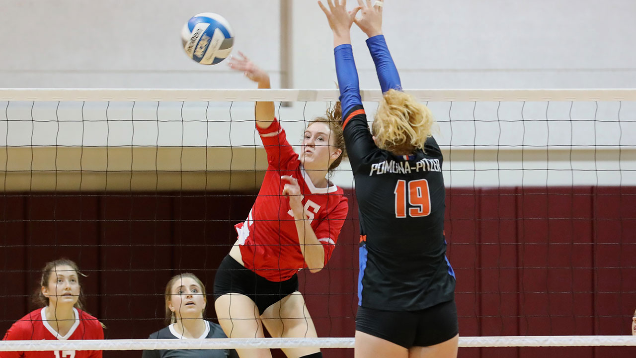 Olivia Sampson hits a volleyball across the net. 