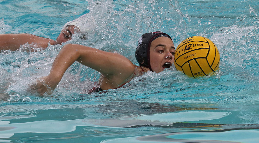 Lauren Dvonch protects the ball while swimming.