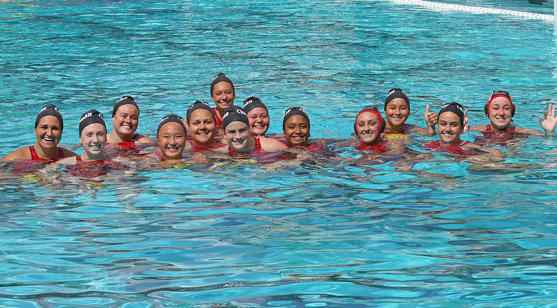 The team stops for a pregame group picture.