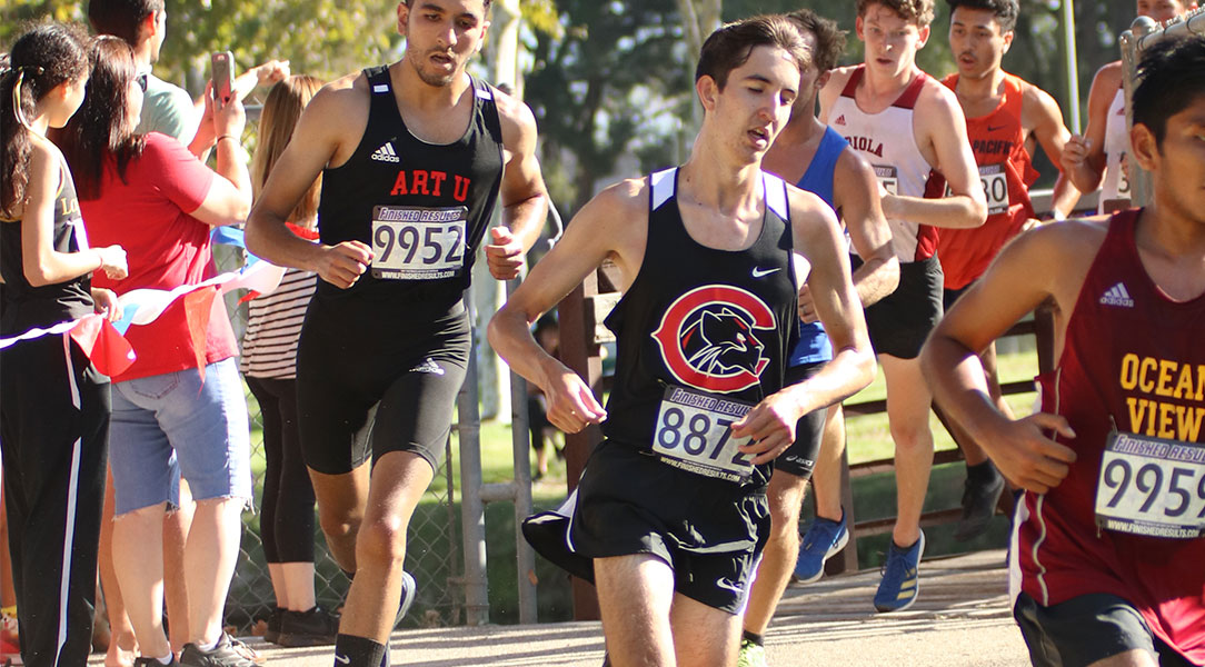 Aiden White runs around a curve.