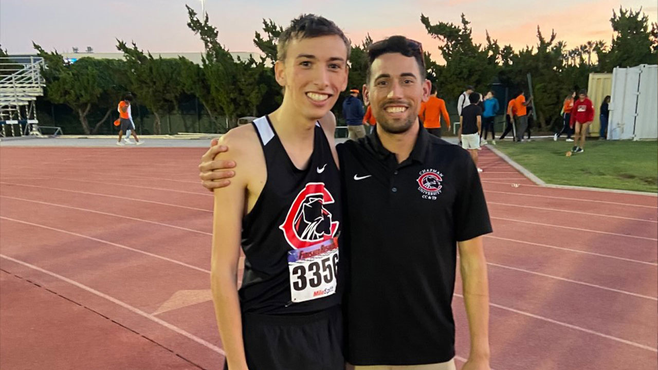 Anthony Hart and Coach Maizland stand on the track after Hart's record-breaking run.