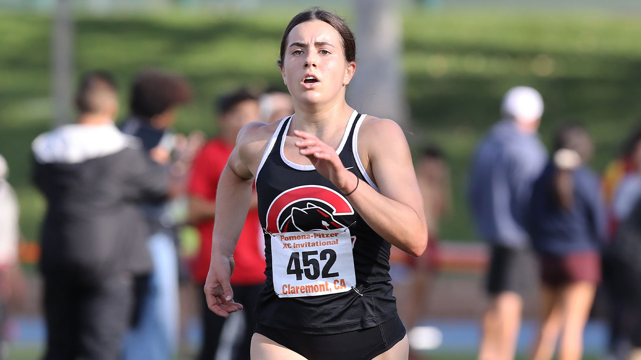 Maddie Mirro running to the finish line.