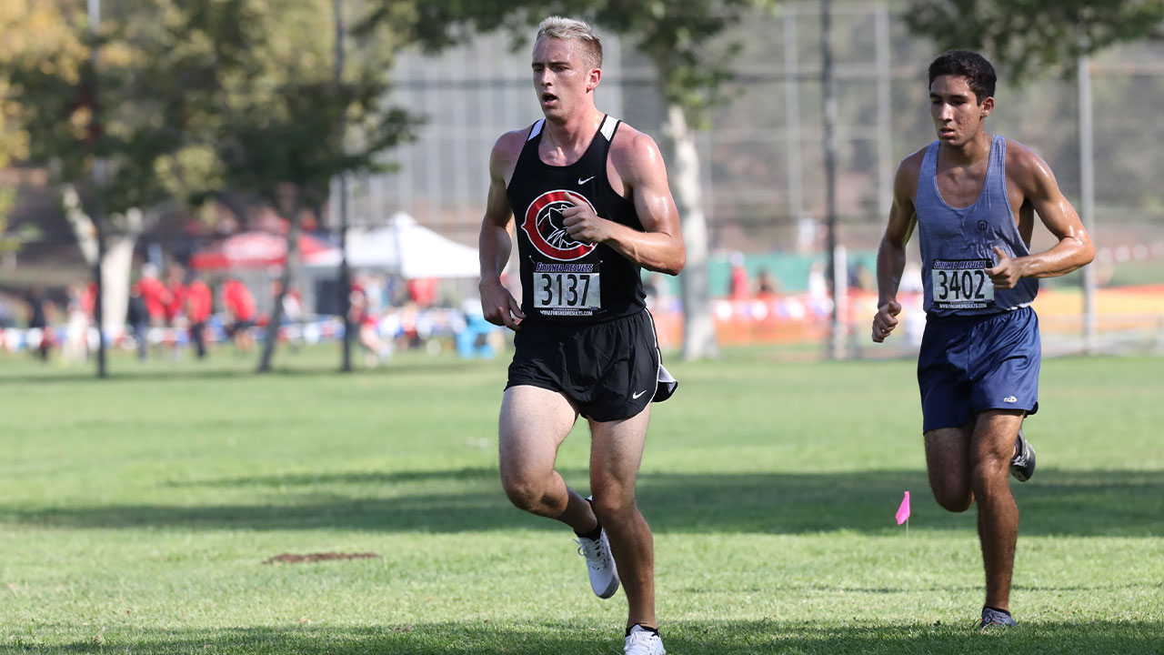 A Chapman runner runs in front of a competitor.